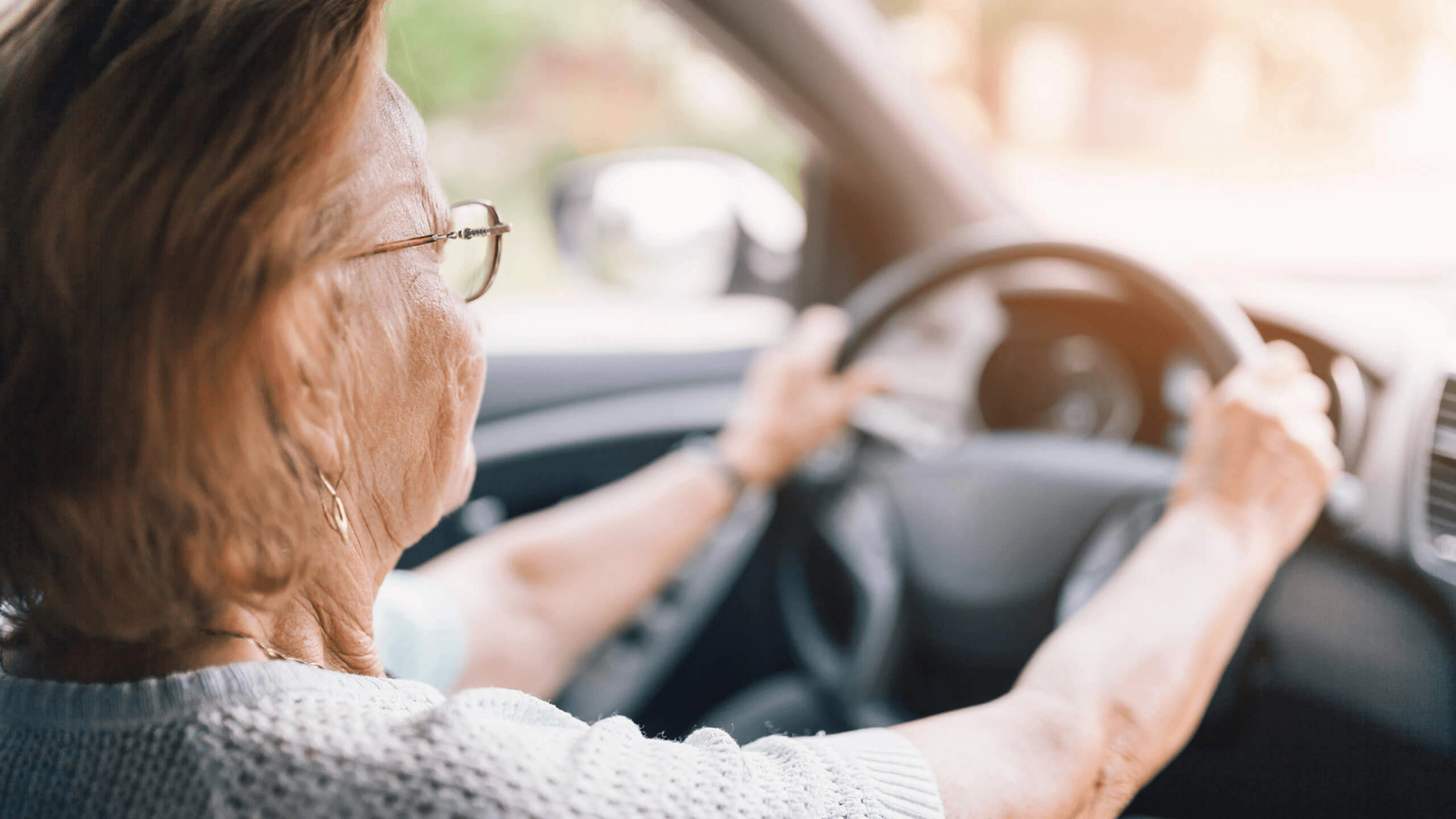 Une vieille dame au volant d'une voiture