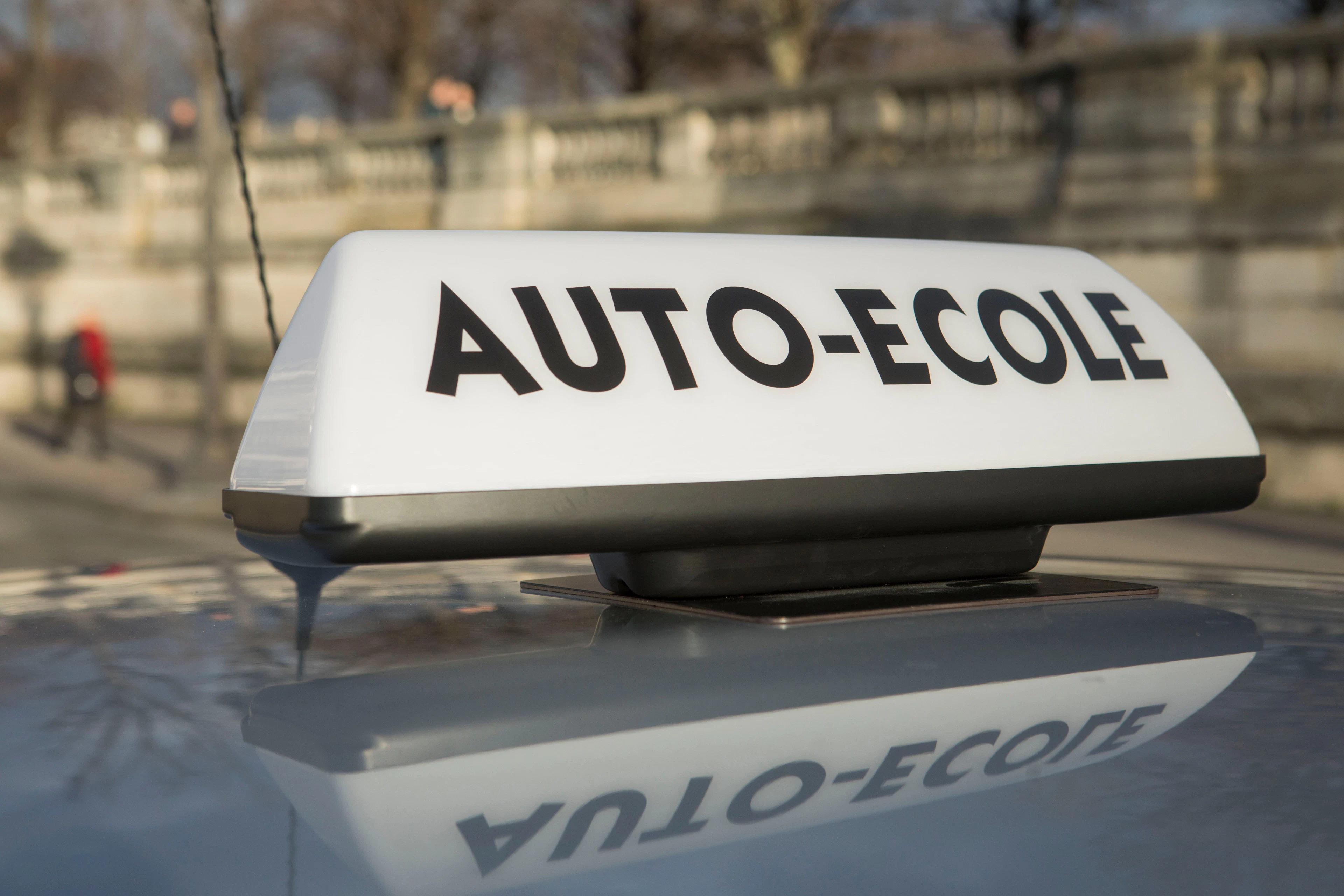 Signe auto-école posé sur le toit d'une voiture